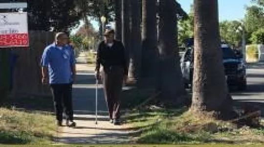 CRT volunteer speaking to senior citizen near crime scene