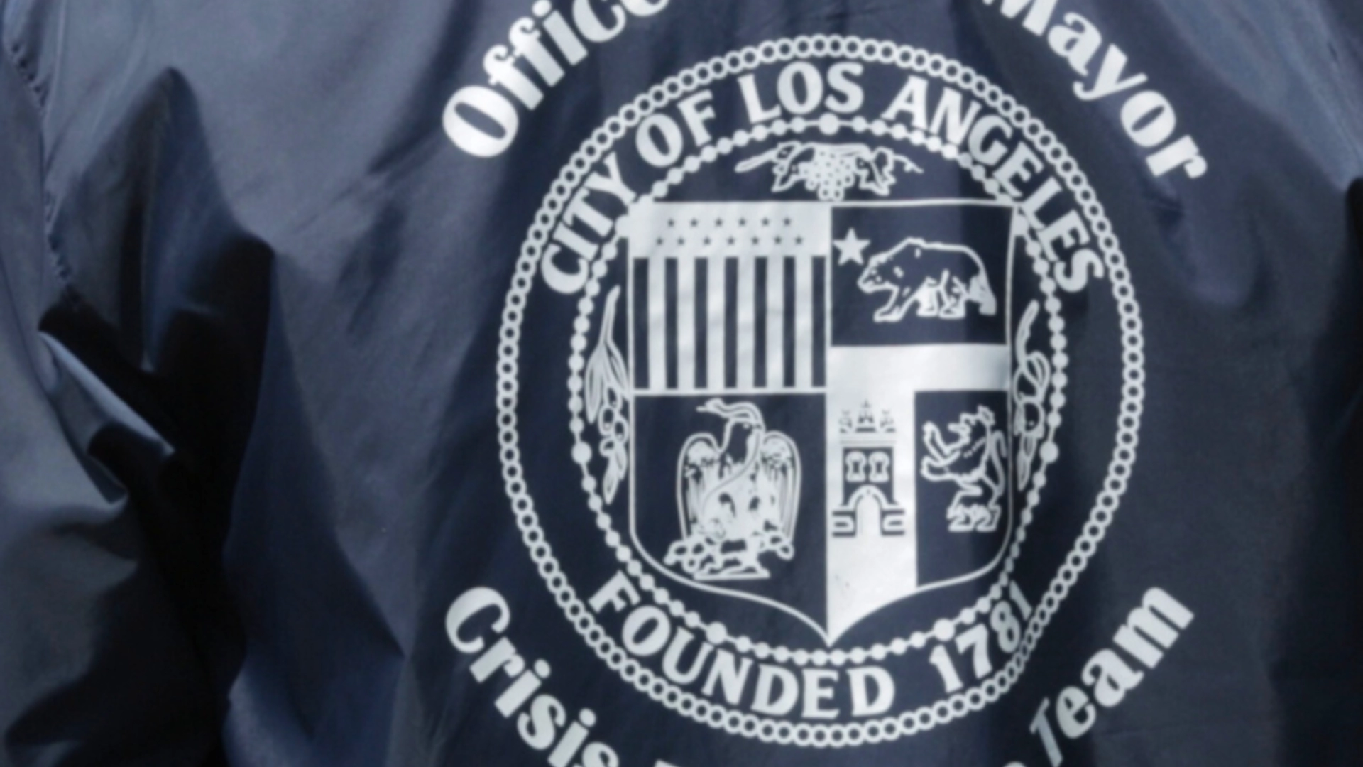 Office of the Mayor - City of Los Angeles - Crisis Response Team logo on the back of a blue jacket