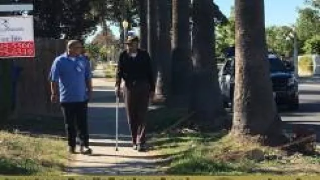 CRT volunteer speaking to senior citizen near crime scene